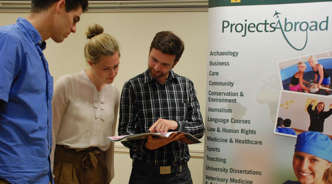 Leads have the volunteer projects and internships explained during an event. Projects Abroad staff talk to potential volunteers during an information event in France.